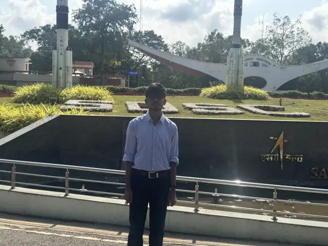 Adithya standing in front of the space centre's memorial garden