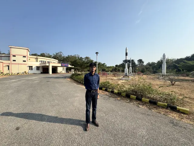 Adithya on the road through Satish Dhawan Space Centre with a launch vehicle model behind