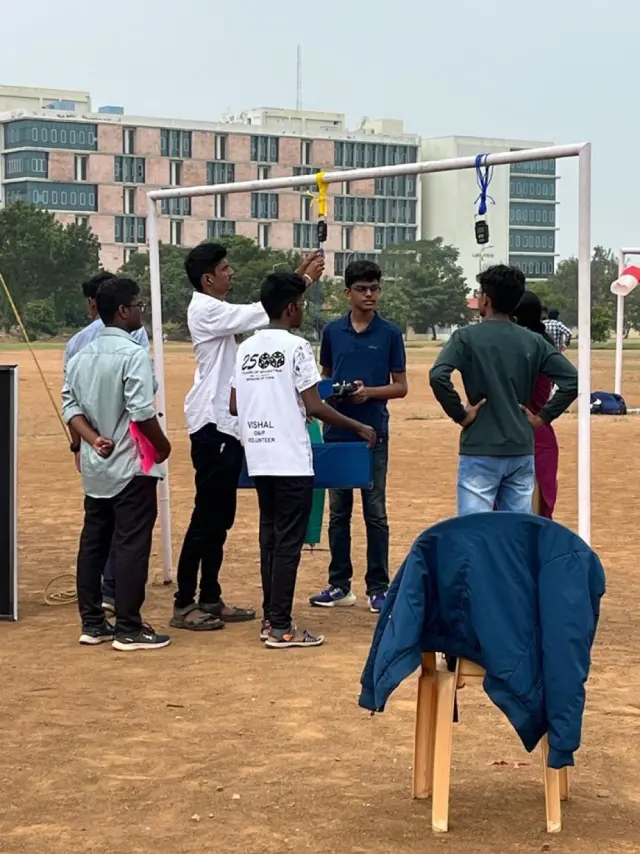 Teams gathered at a PVC frame on the field where officials check the aircraft
